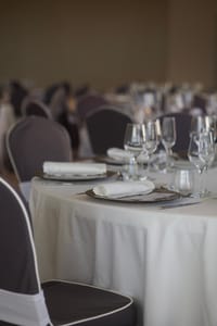 Elegant banquet hall setup with neatly arranged tableware, highlighting sophistication.